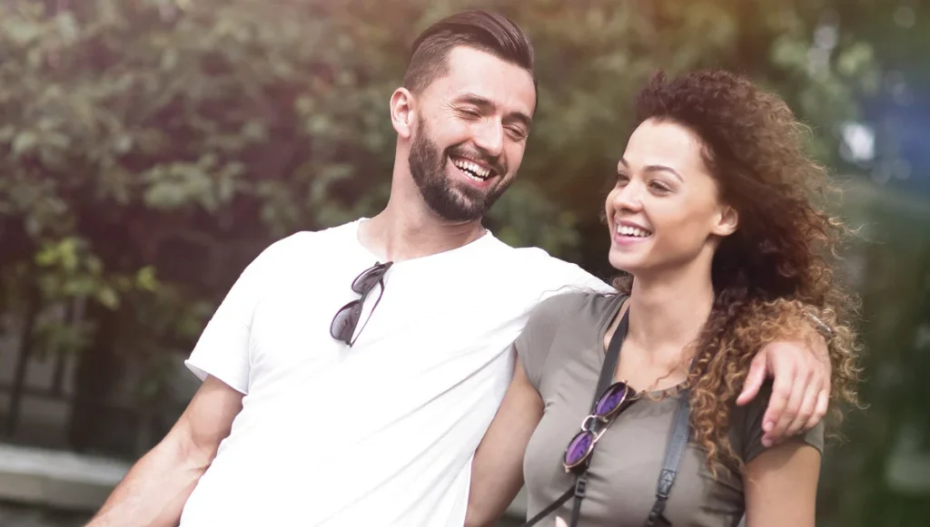 Cheerful young couple walking on urban street