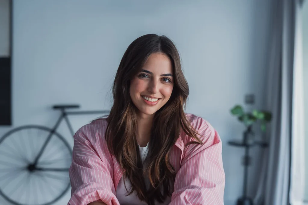 . Young confident business woman in casual, entrepreneur, blogger posing at home office workplace table enjoying indoor, smiling at camera
