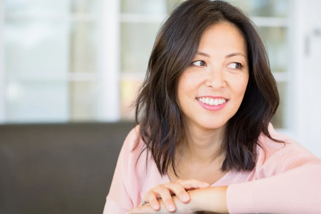 Portrait of an Asian woman smiling.