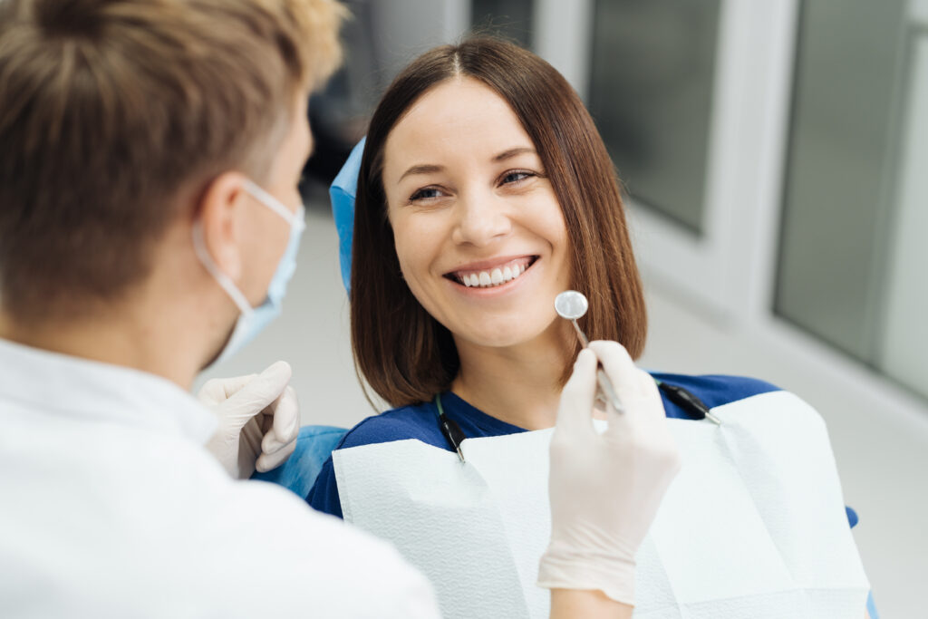 Dentist discussing treatment plan with a new patient during a first visit exam