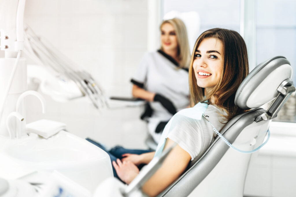 Dentist examining a patient's smile during a dental bridge care checkup