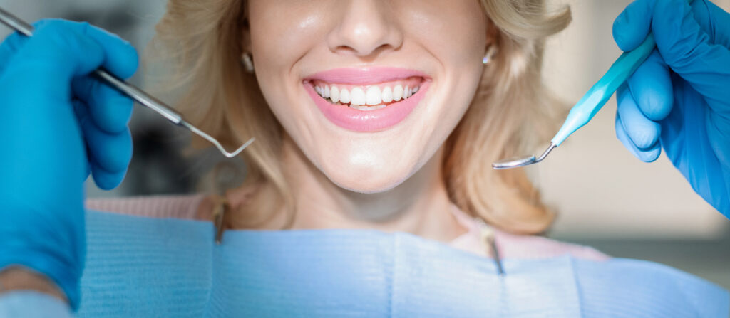 Dentist examining a patient's teeth during a checkup for a missing tooth
