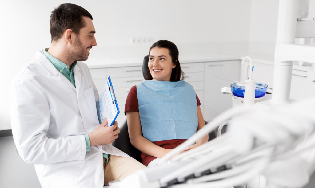Dentist discussing out-of-network insurance benefits with a patient at the dental office
